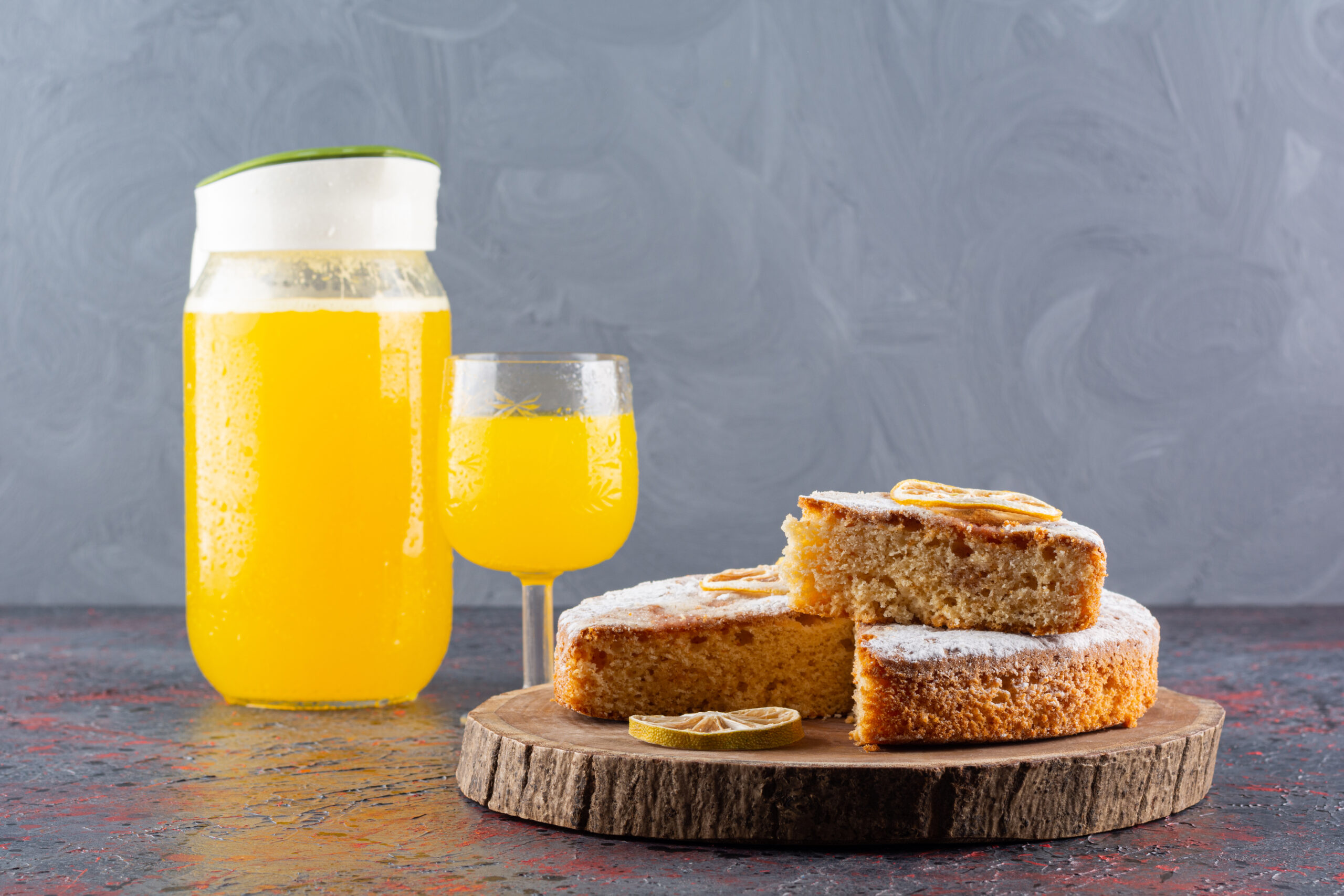 Close up photo of cake slices and fresh juice on rustic background. High quality photo